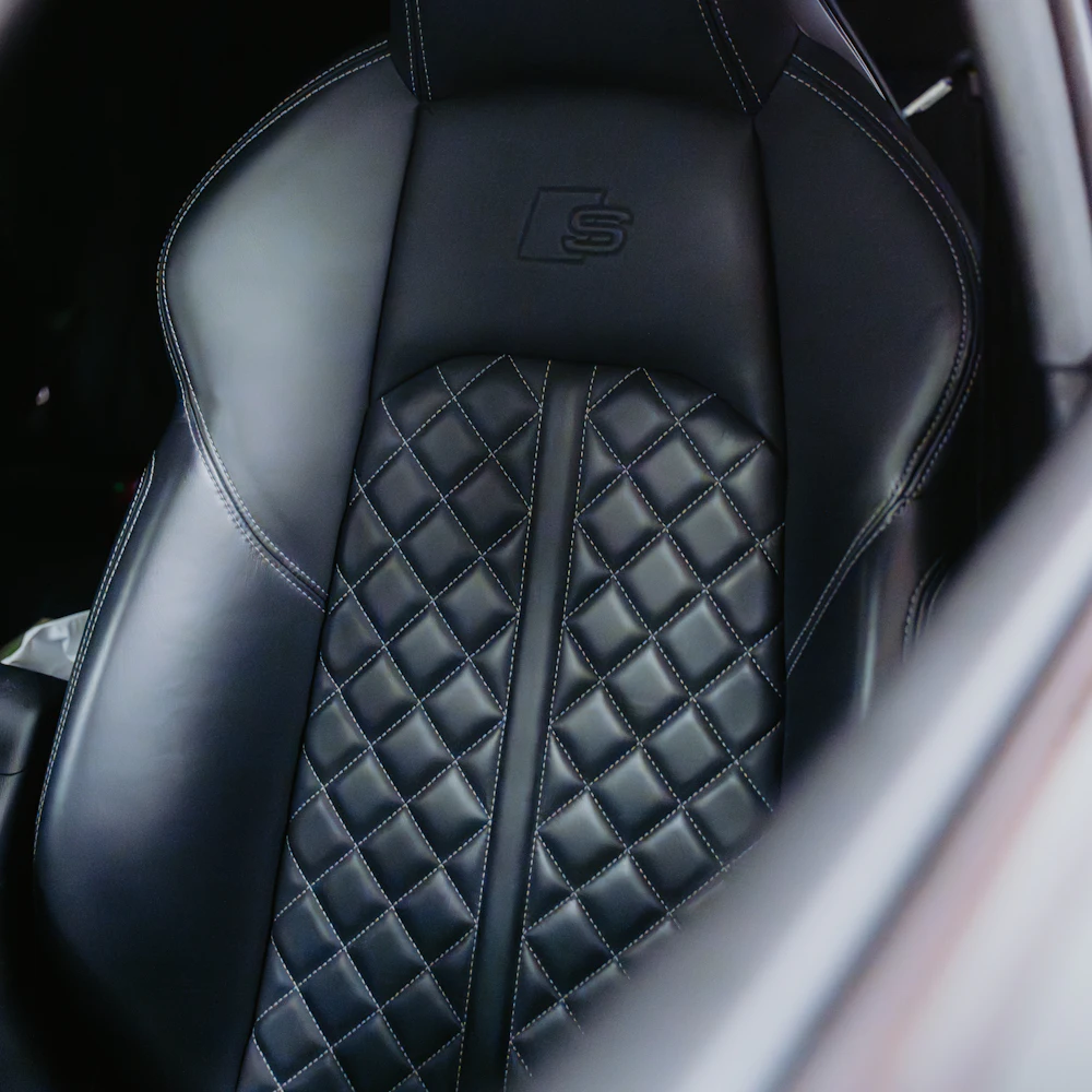 Black leather car seat cover with diamond stitching