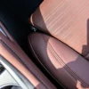 Perforated brown leather seat cover with contrast stitching