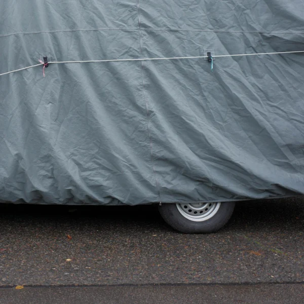 Close-up of a car top cover with tie-down strap