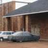 top-cover-sedan-grey Sedan protected with a grey car top cover